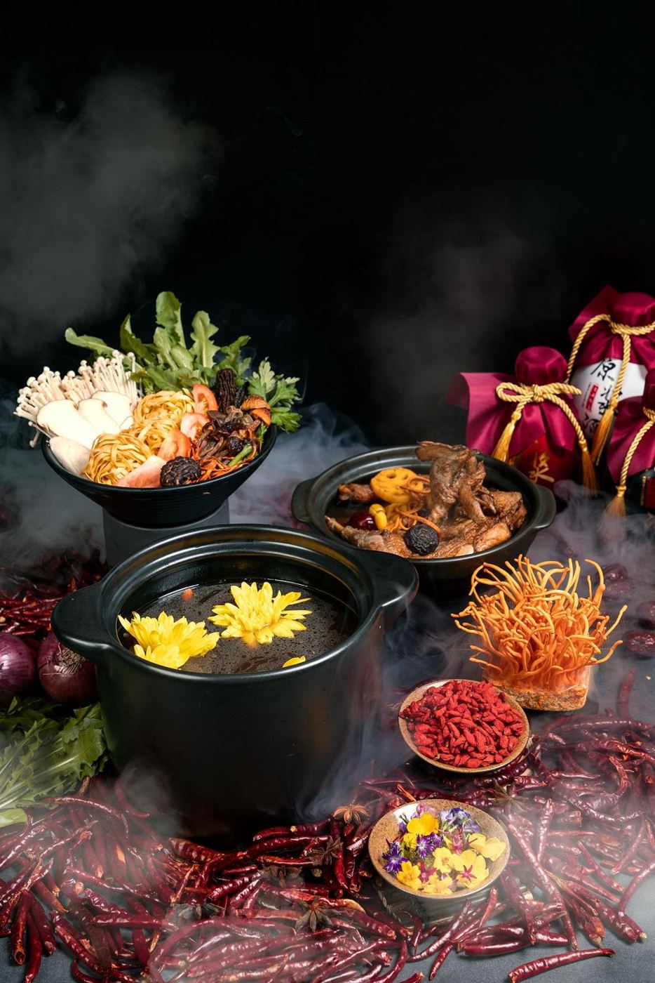 A table of Mughlai dishes in brass bowls lit by candlelight